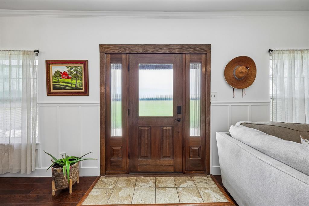 331 Radecke Road Krum, TX 76249 - Photo 7 of 40 Rich wood-finish entry door with side lites and transom window