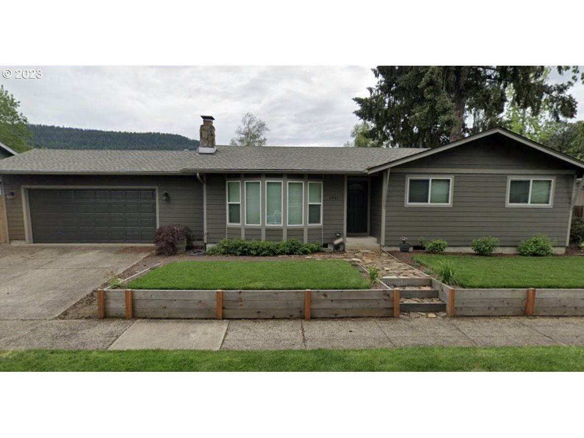6941 D Street Springfield, OR 97478 - Photo 1 of 1 a front view of a house with a yard and garage