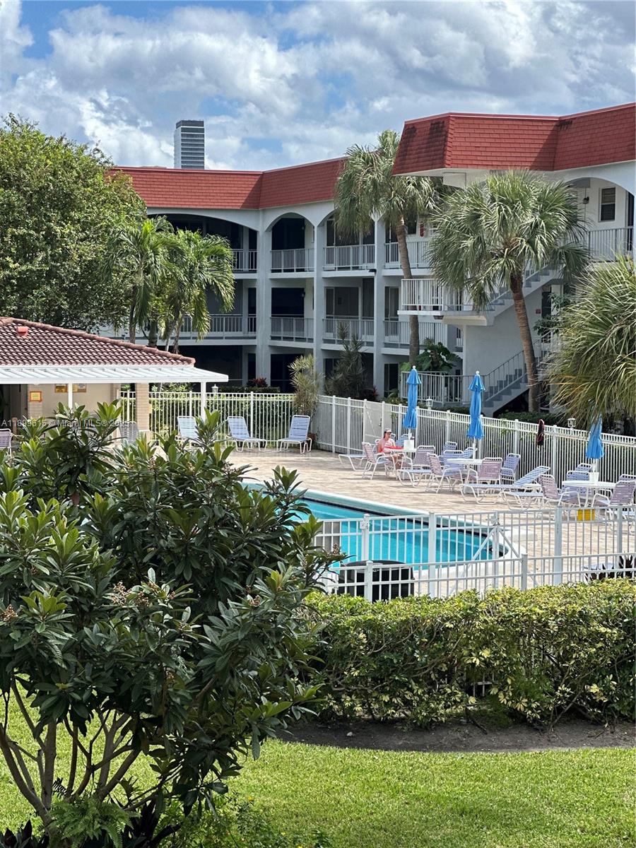 581 Blue Heron Drive, Unit 208B Hallandale Beach, FL 33009 - Photo 1 of 23 a view of a house with a yard and potted plants