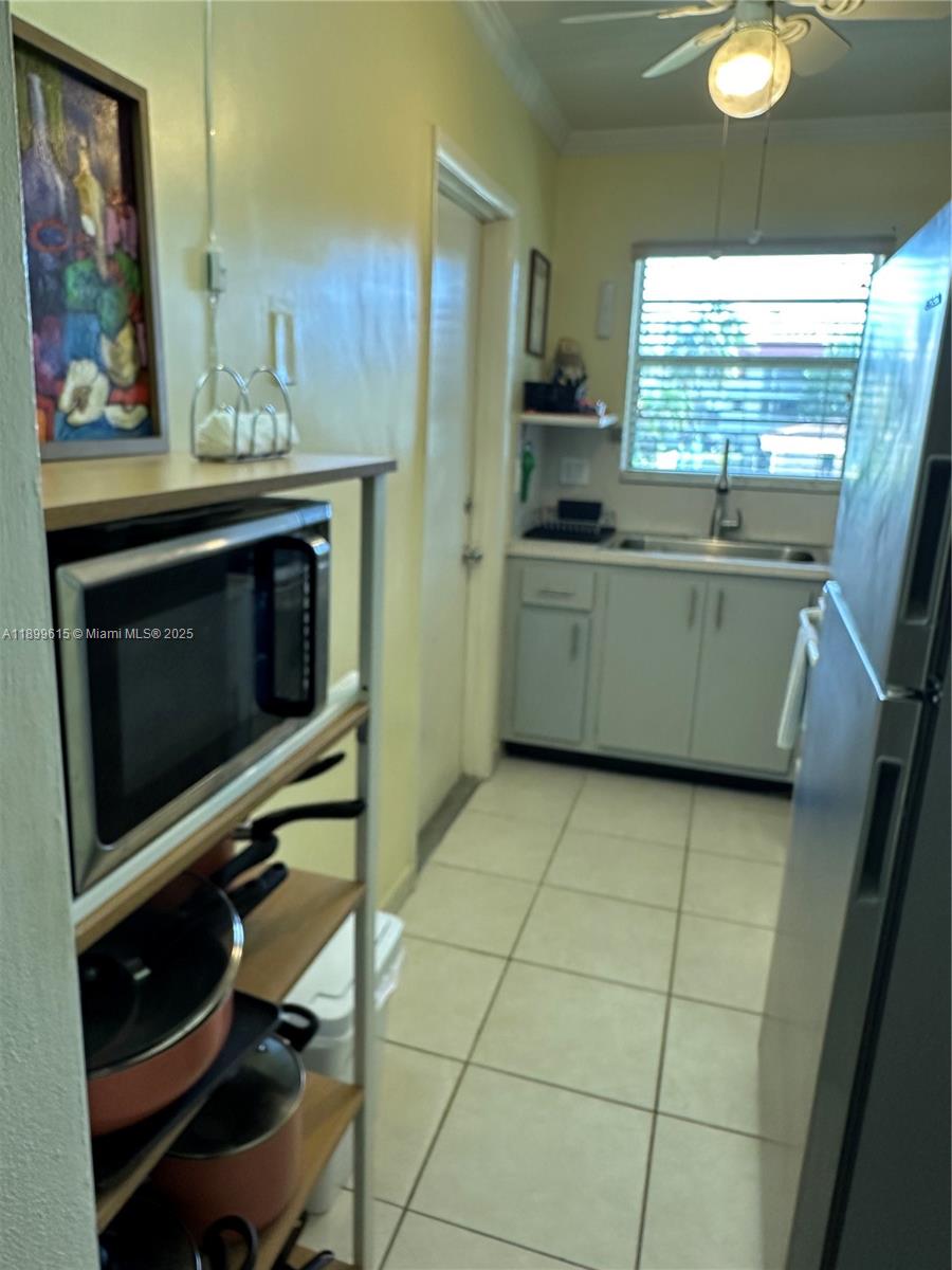 581 Blue Heron Drive, Unit 208B Hallandale Beach, FL 33009 - Photo 12 of 23 a kitchen with a stove and a microwave