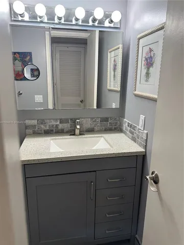 a bathroom with a toilet sink and shower