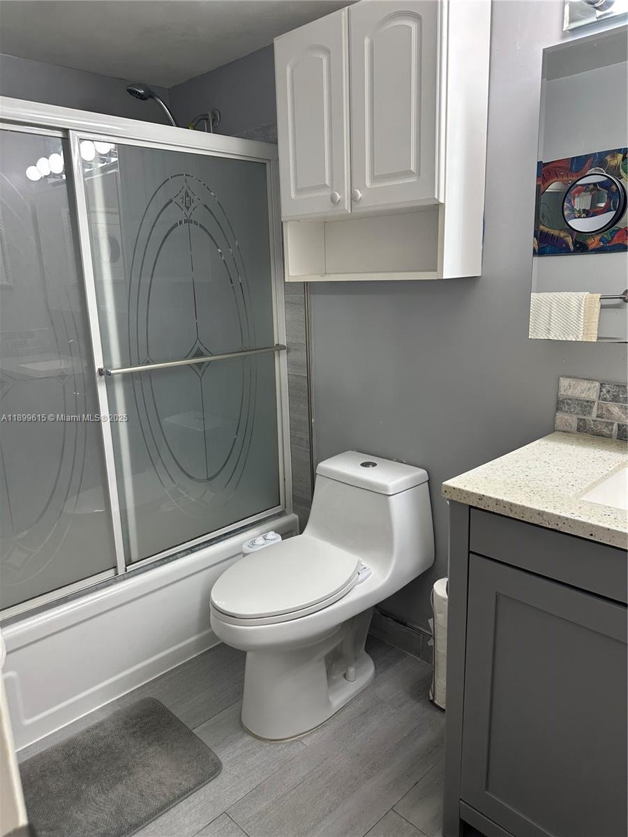 581 Blue Heron Drive, Unit 208B Hallandale Beach, FL 33009 - Photo 17 of 23 a bathroom with a toilet sink and shower