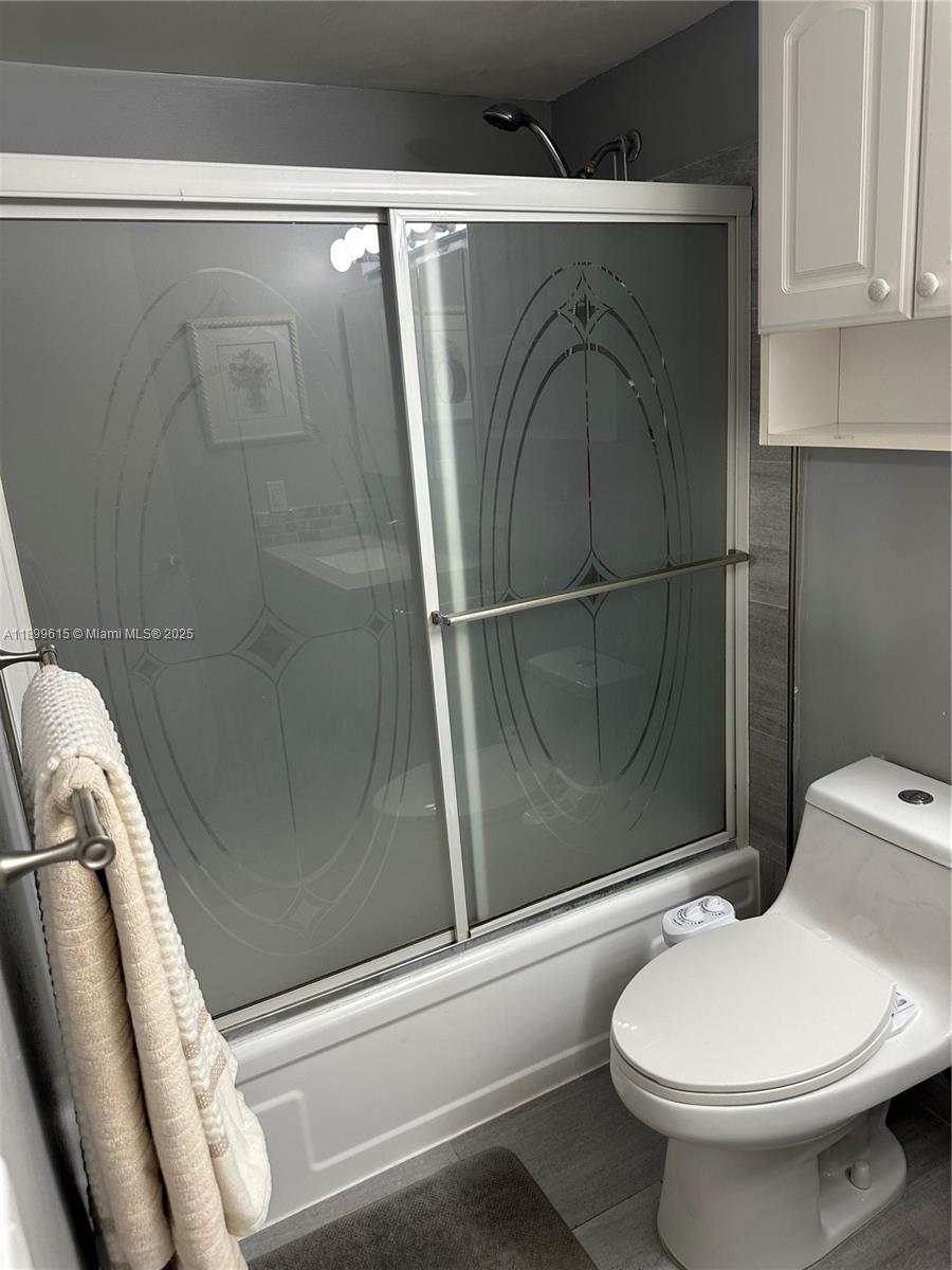 581 Blue Heron Drive, Unit 208B Hallandale Beach, FL 33009 - Photo 18 of 23 a bathroom with a toilet and a shower