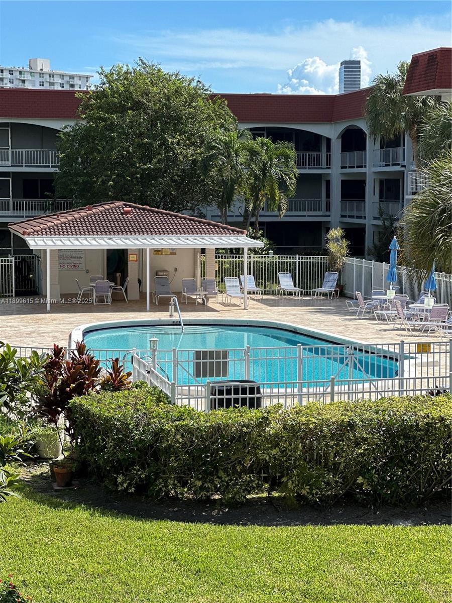 581 Blue Heron Drive, Unit 208B Hallandale Beach, FL 33009 - Photo 2 of 23 an aerial view of a house with a garden and swimming pool