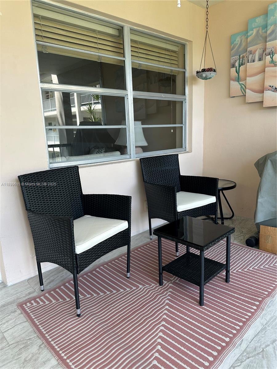 581 Blue Heron Drive, Unit 208B Hallandale Beach, FL 33009 - Photo 6 of 23 a outdoor living space with furniture