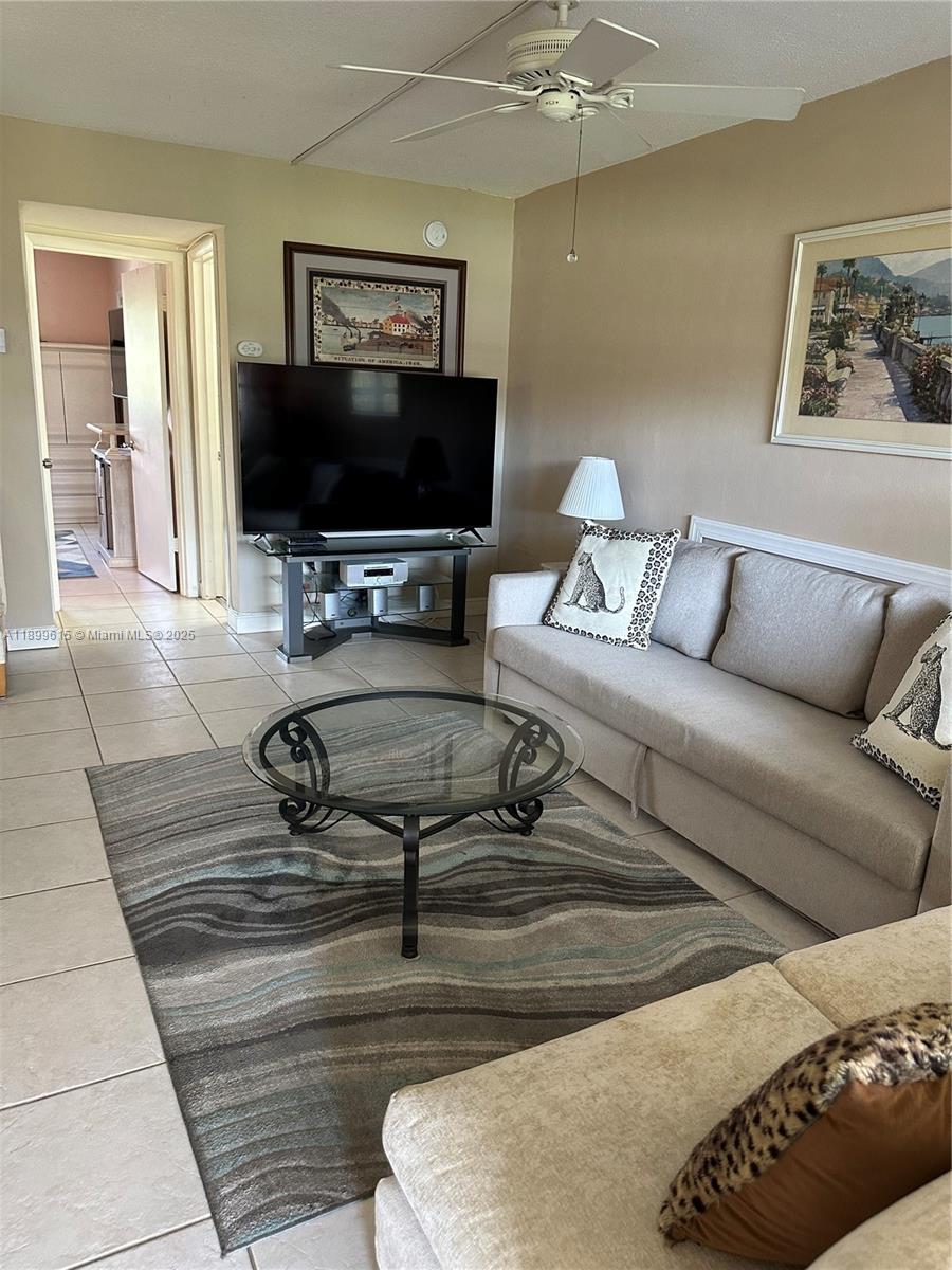 581 Blue Heron Drive, Unit 208B Hallandale Beach, FL 33009 - Photo 9 of 23 a living room with furniture and a flat screen tv