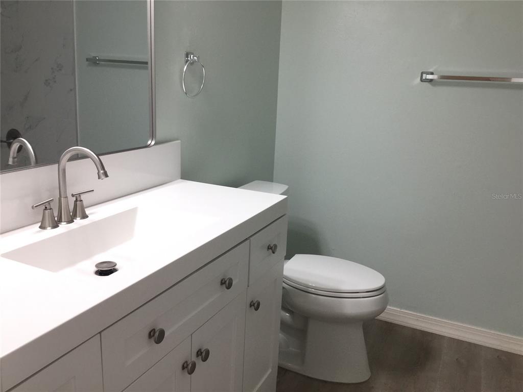 1744 Southwest 108th Lane, Unit B Ocala, FL 34476 - Photo 13 of 15 a bathroom with a sink a toilet and a mirror