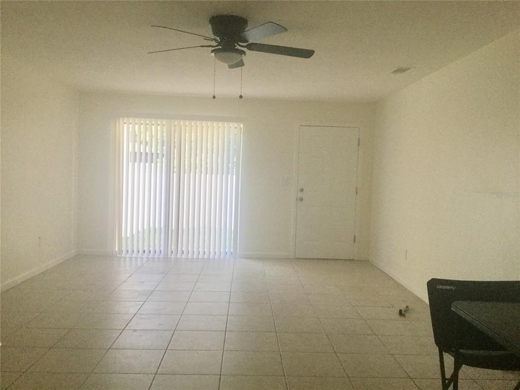1744 Southwest 108th Lane, Unit B Ocala, FL 34476 - Photo 3 of 15 a view of an empty room with a window