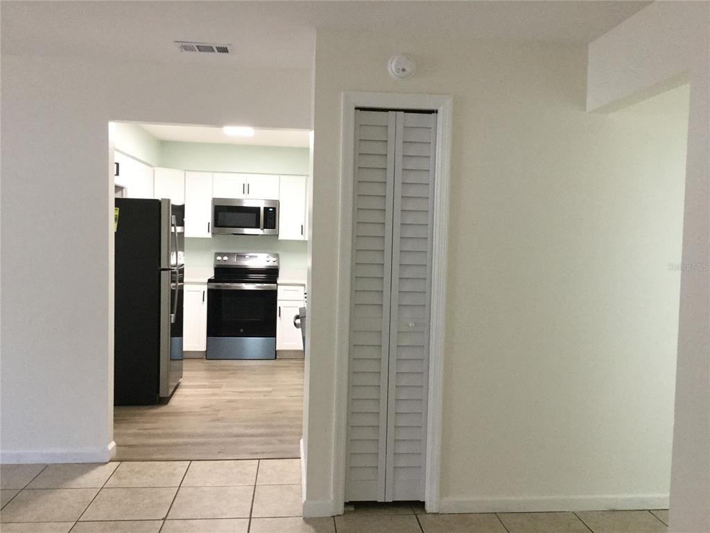 1744 Southwest 108th Lane, Unit B Ocala, FL 34476 - Photo 4 of 15 a kitchen with stainless steel appliances kitchen island granite countertop a refrigerator and a sink