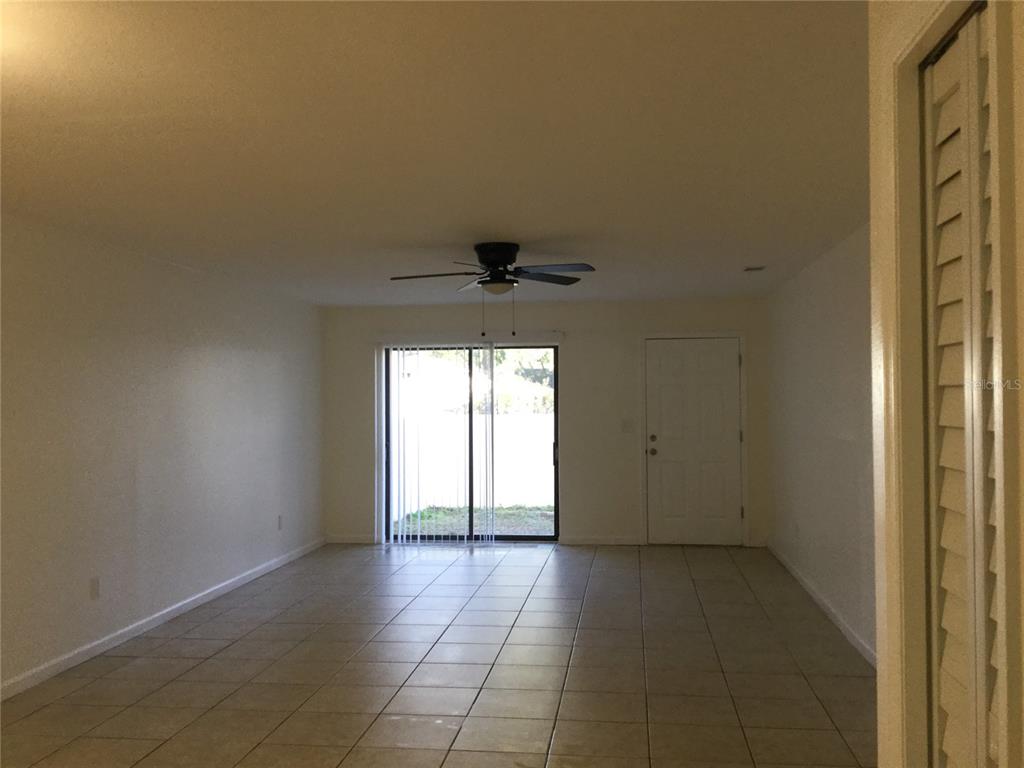 1744 Southwest 108th Lane, Unit B Ocala, FL 34476 - Photo 8 of 15 an empty room with a empty space and windows