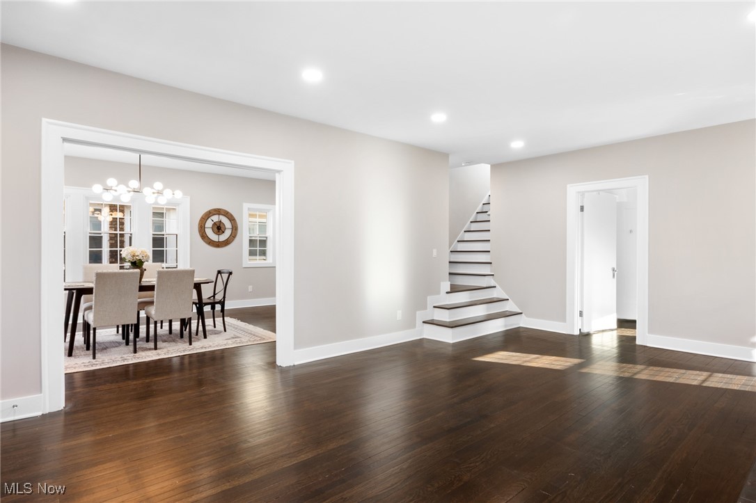 2854 Corydon Road Cleveland, OH 44118 - Photo 7 of 41 Living area with recessed lighting, an inviting chandelier, stairway, and dark wood-style flooring