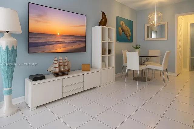 a kitchen with stainless steel appliances a white table chairs and a refrigerator