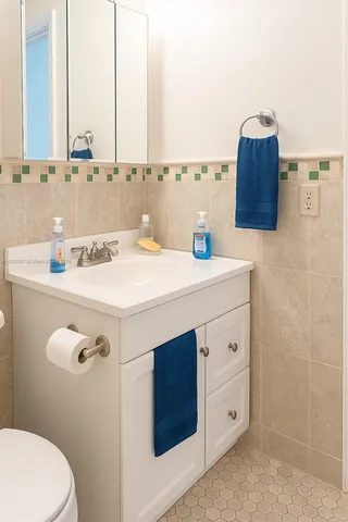 a bathroom with a sink vanity and toilet