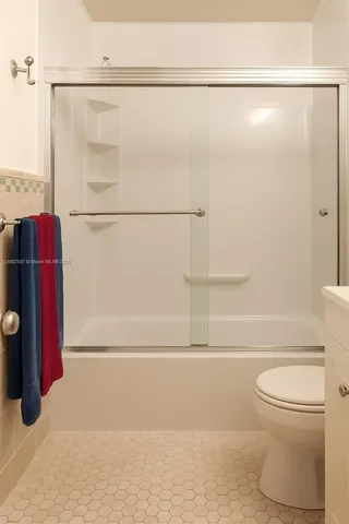 a bathroom with a shower and a toilet