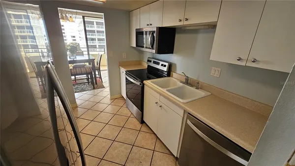 a utility room with sink dryer and washer