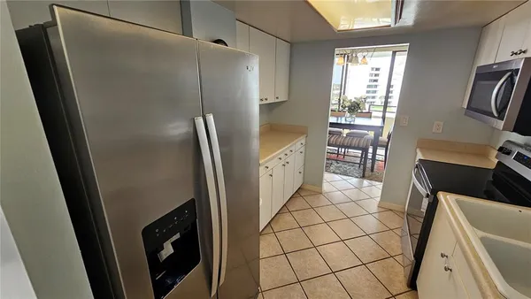a kitchen with a refrigerator and a stove