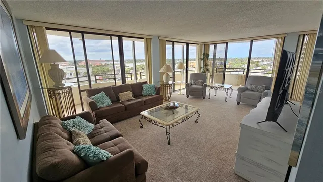 a living room with furniture a flat screen tv and a window