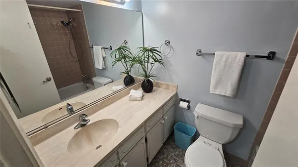 a bathroom with a sink toilet and mirror