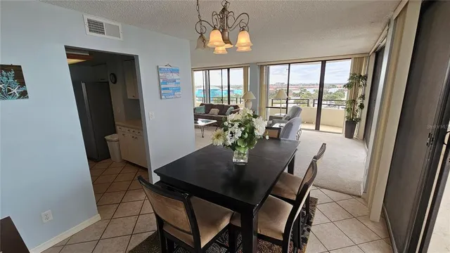 a bedroom with a bed and a flat tv screen on a dresser