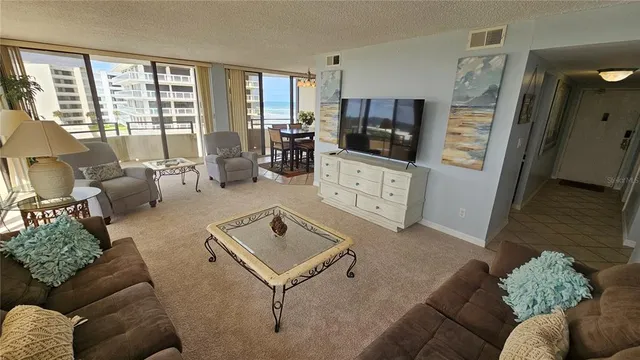a bedroom with a bed and a view of living room