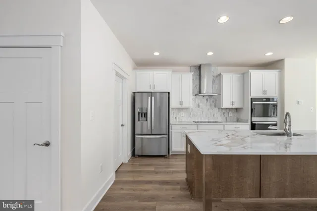a view of a room with wooden flooring and ceiling fan