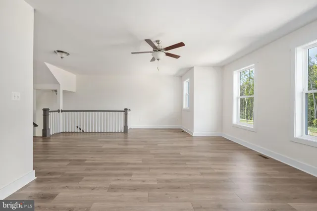 a view of a livingroom with a ceiling fan and window