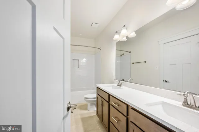 a bathroom with a double vanity sink and mirror