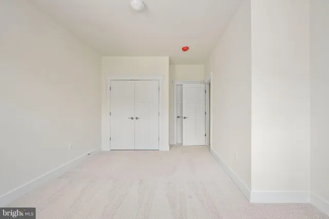 a view of a small space with wooden floor and a window