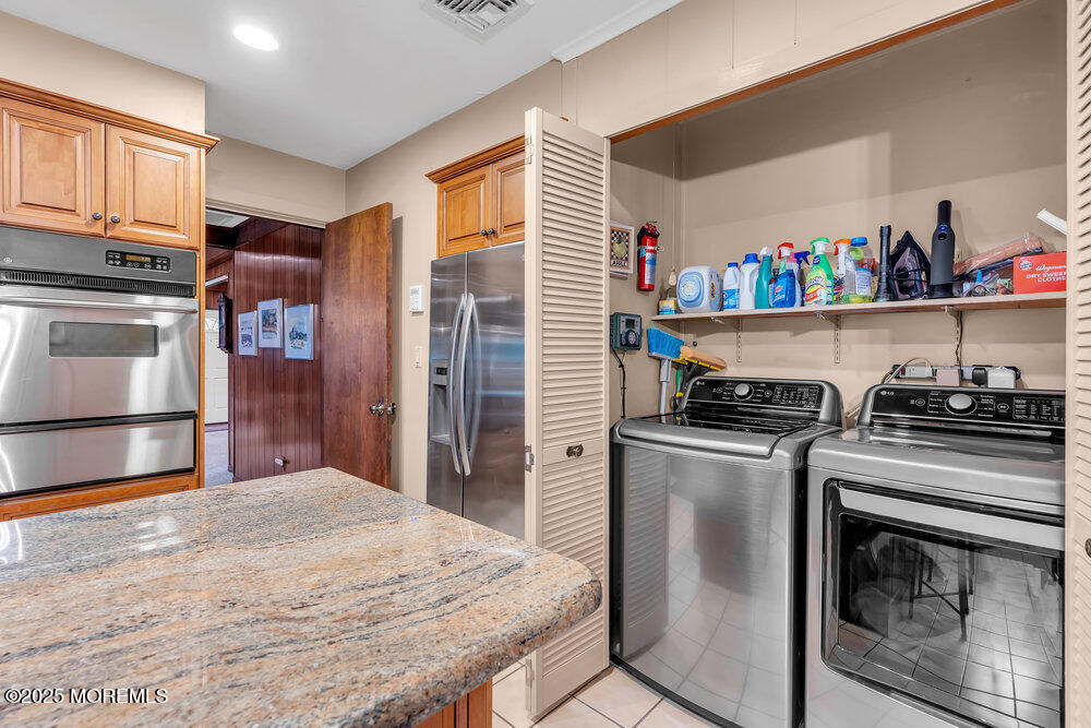 2308 Logan Road Asbury Park, NJ 07712 - Photo 18 of 37 a kitchen with stainless steel appliances granite countertop a stove a refrigerator and a refrigerator