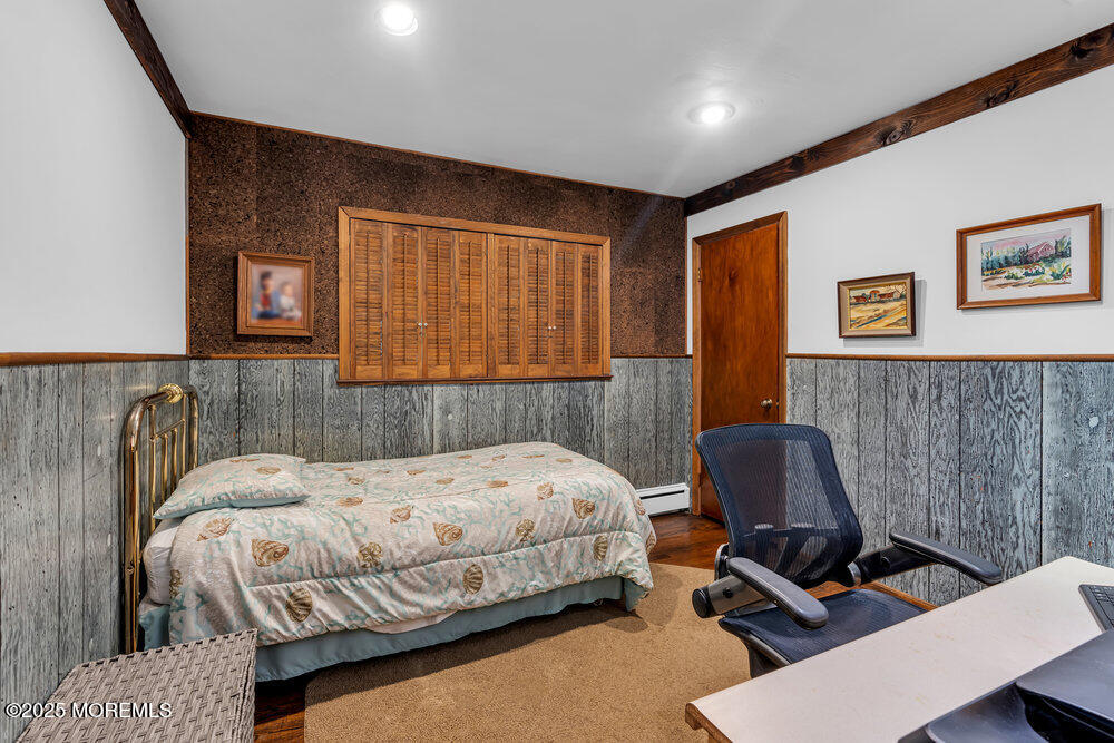 2308 Logan Road Asbury Park, NJ 07712 - Photo 24 of 37 a bedroom with a bed chair and a desk