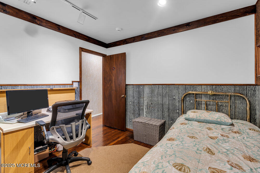 2308 Logan Road Asbury Park, NJ 07712 - Photo 25 of 37 a bedroom with a bed and wooden floor