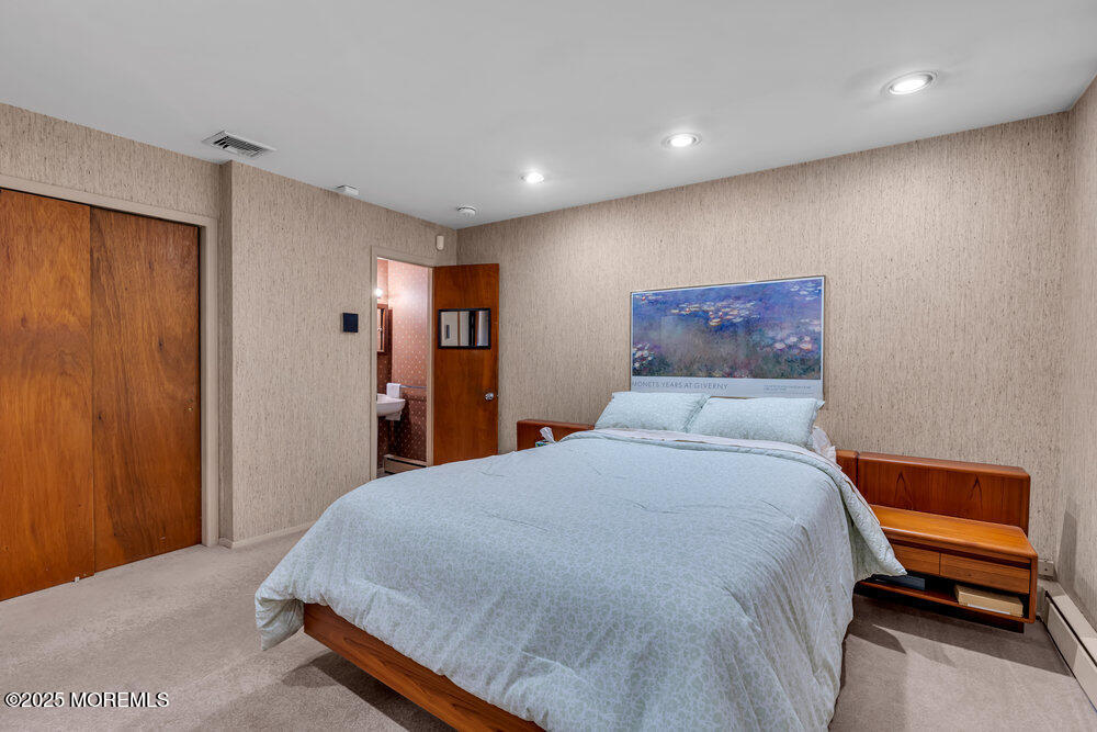 2308 Logan Road Asbury Park, NJ 07712 - Photo 28 of 37 a bedroom with a bed and a painting