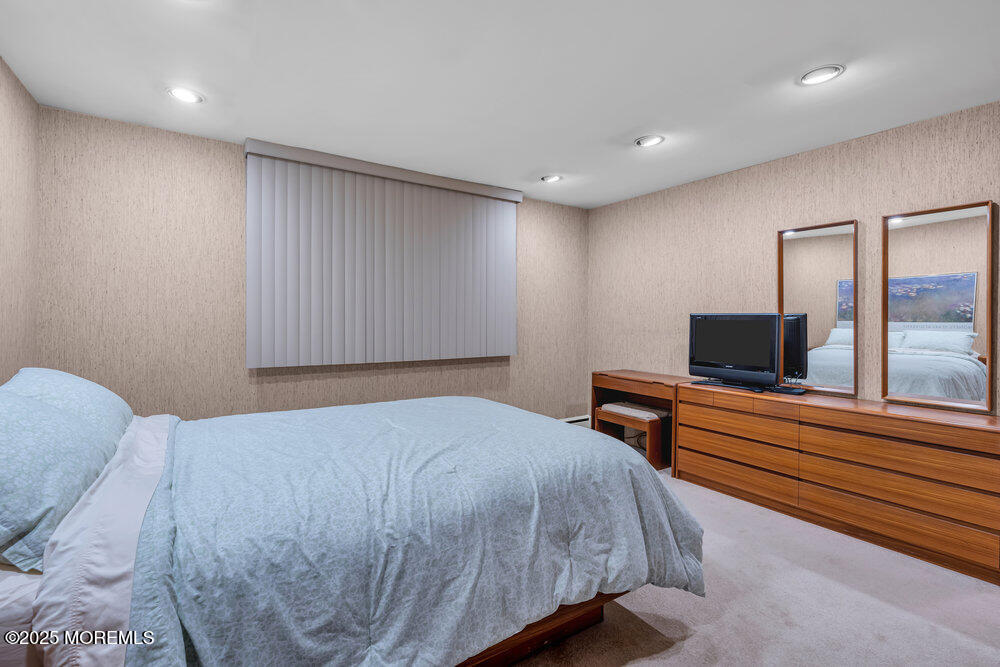 2308 Logan Road Asbury Park, NJ 07712 - Photo 29 of 37 a bedroom with a bed and a flat screen tv