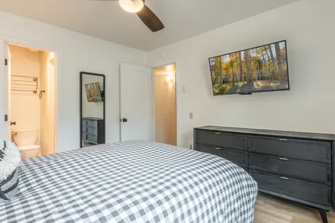 a bedroom with a bed and a painting on the wall