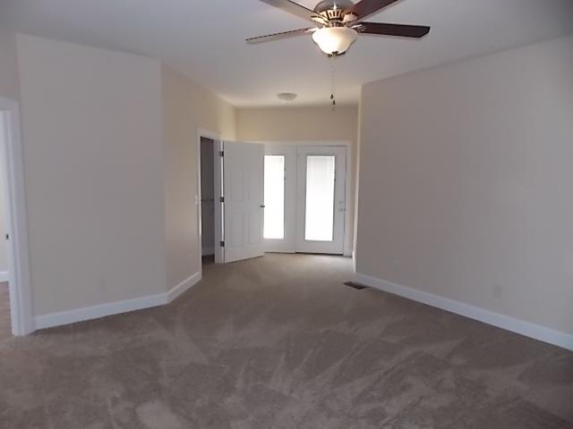 663 Sugar Flat Road Lebanon, TN 37087 - Photo 12 of 16 an empty room with a chandelier fan and windows