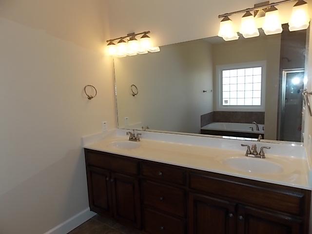 663 Sugar Flat Road Lebanon, TN 37087 - Photo 15 of 16 a bathroom with a double vanity sink and a mirror