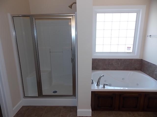 663 Sugar Flat Road Lebanon, TN 37087 - Photo 16 of 16 a bathroom with a bathtub and a window