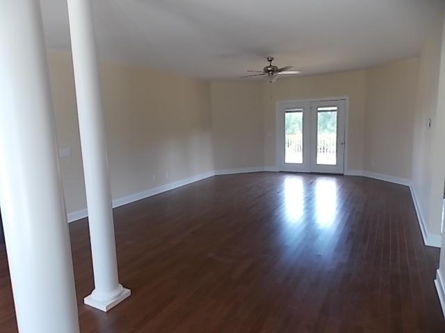 663 Sugar Flat Road Lebanon, TN 37087 - Photo 3 of 16 an empty room with wooden floor fan and windows