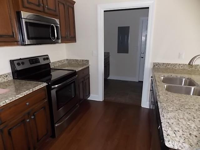 663 Sugar Flat Road Lebanon, TN 37087 - Photo 9 of 16 a kitchen with granite countertop a stove and a microwave