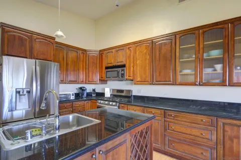 a kitchen with stainless steel appliances granite countertop a sink stove and cabinets