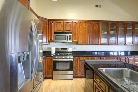 a kitchen with a stove a sink and a refrigerator