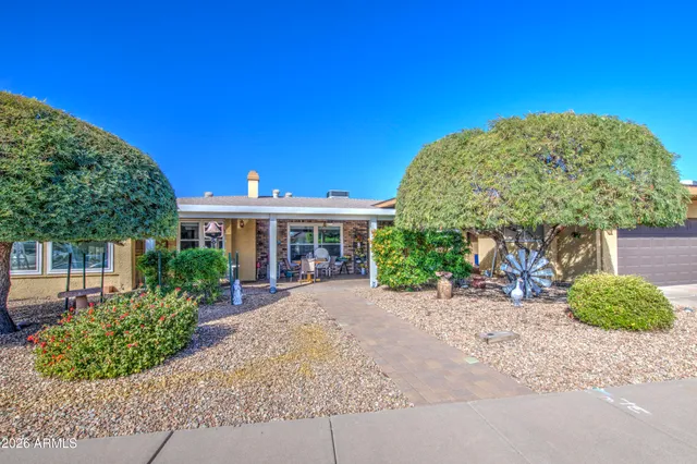 a front view of a house with a garden