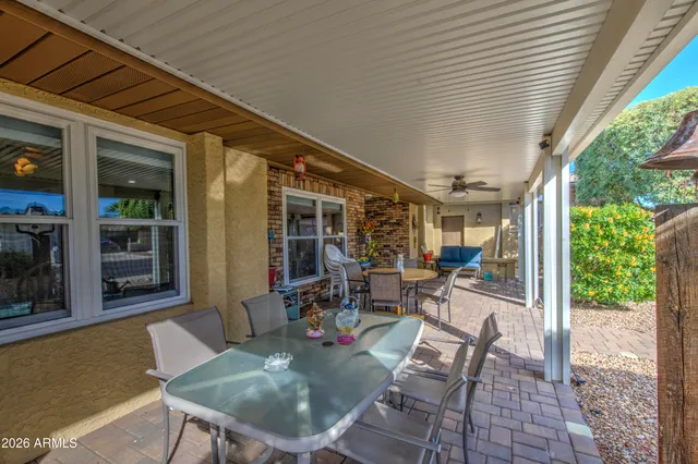 a view of a patio with table and chairs and potted plants