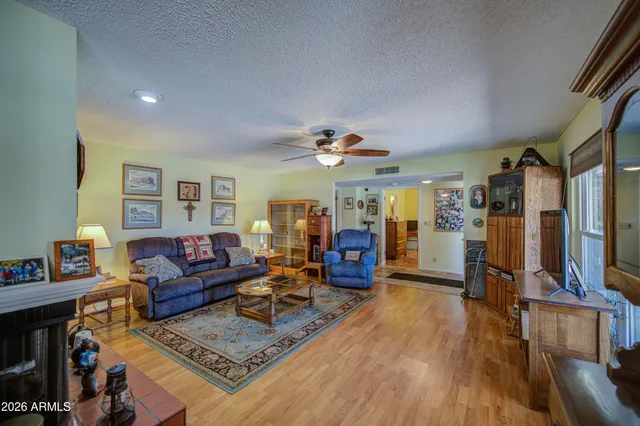 a living room with lots of furniture and wooden floor