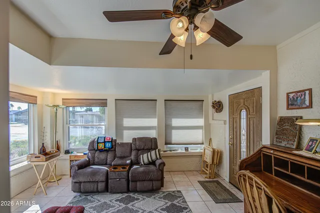 a living room with furniture and a large window