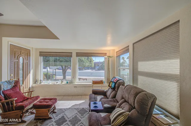 a living room with furniture and a large window