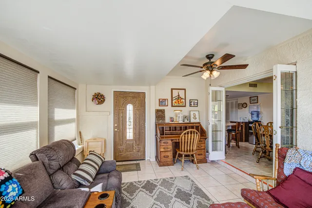 a living room with furniture and a view of bedroom