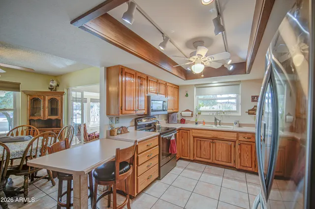 a large kitchen with a table and chairs