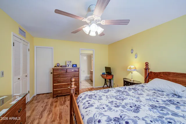 a bedroom with a bed and wooden floor