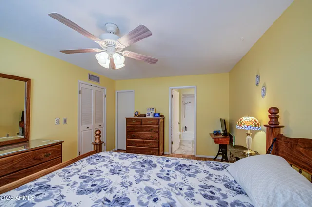 a bedroom with a bed and a dresser